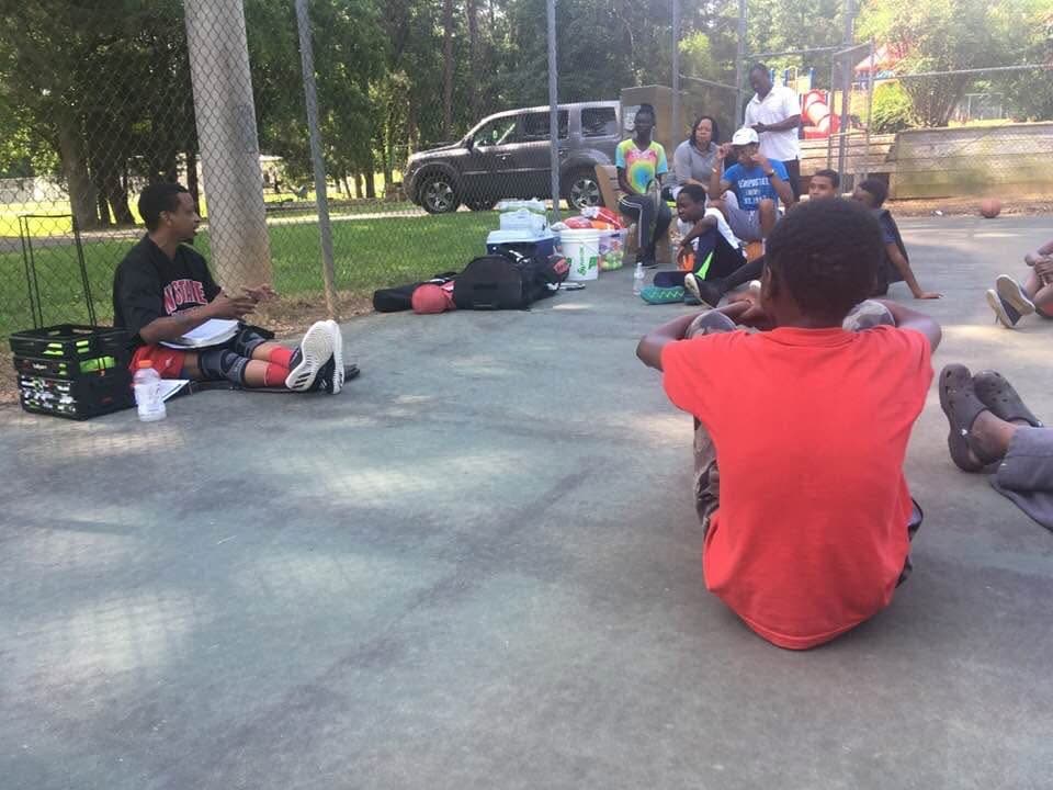 Coach Kenya Davis leading a group athlete development conversation